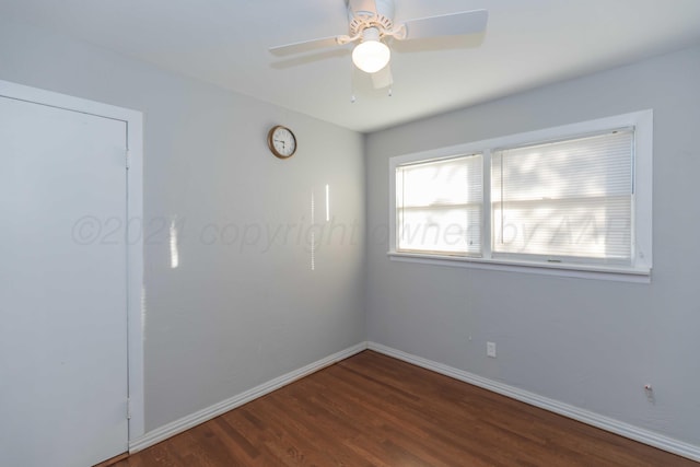 unfurnished room featuring dark hardwood / wood-style floors and ceiling fan