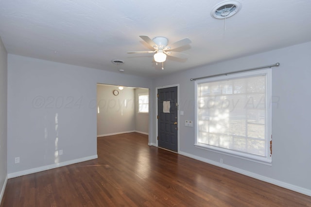 unfurnished room featuring ceiling fan and dark wood-type flooring