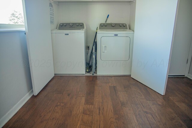 washroom featuring baseboards, wood finished floors, washer and clothes dryer, and laundry area