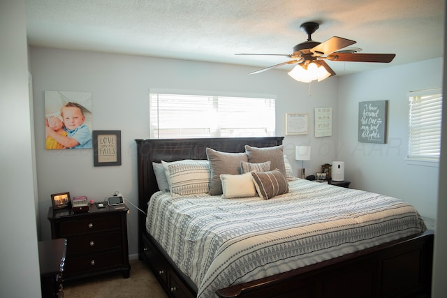 bedroom featuring a ceiling fan and carpet