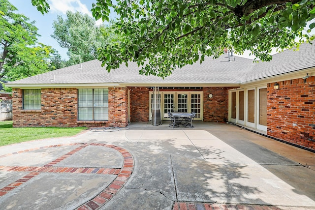 2604 Hawthorne Dr, Amarillo, TX 79109 - rear view of house with roof with shingles, a patio area, and brick siding