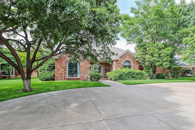 2604 Hawthorne Dr, Amarillo, TX 79109 - obstructed view of property with a front yard, brick siding, and a shingled roof