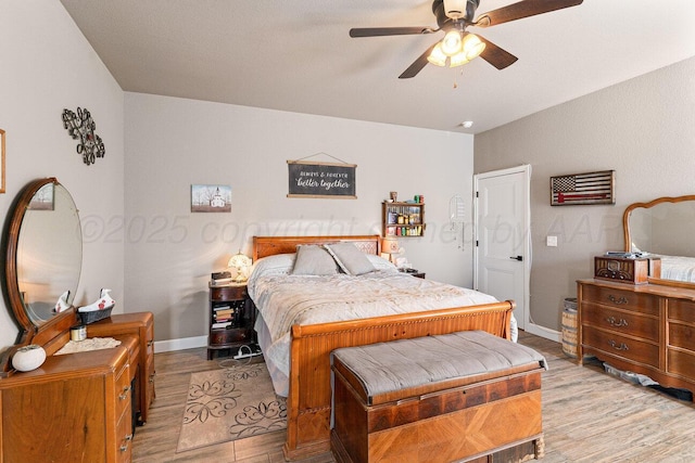 bedroom with ceiling fan and light wood-type flooring