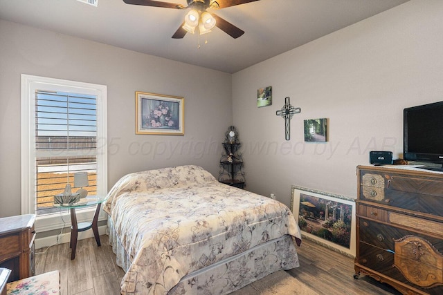 bedroom featuring wood-type flooring and ceiling fan