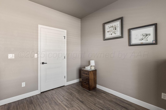 bedroom with dark hardwood / wood-style flooring