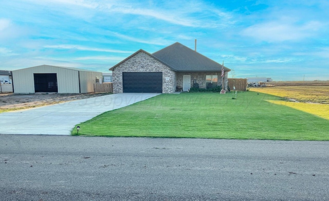 view of front facade with stone siding, an attached garage, concrete driveway, and a front yard