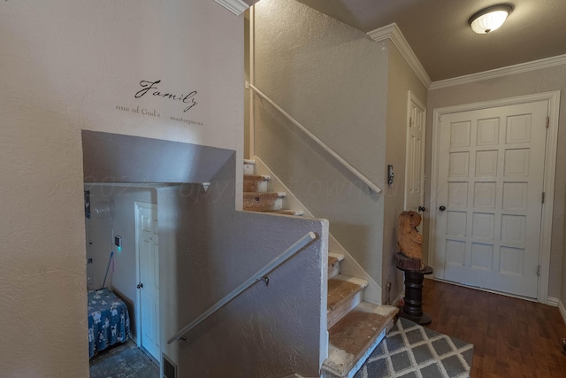 stairs featuring wood-type flooring and ornamental molding