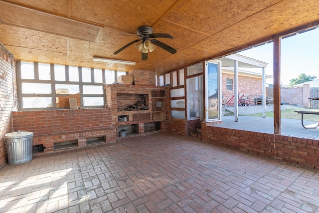 unfurnished sunroom with ceiling fan