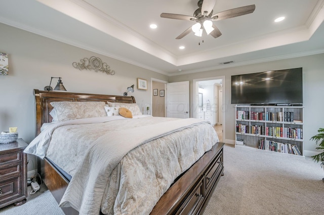 bedroom with ceiling fan, a raised ceiling, light colored carpet, and crown molding