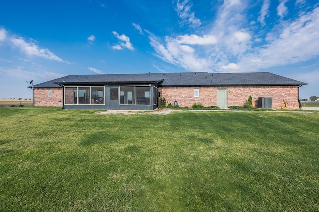 back of property featuring a sunroom, a yard, and cooling unit