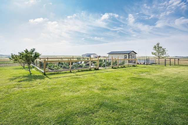 view of yard with a rural view and an outdoor structure