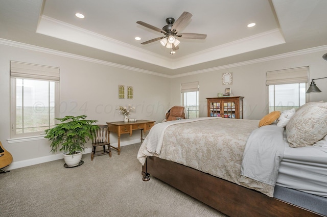 carpeted bedroom with a raised ceiling, ceiling fan, and ornamental molding