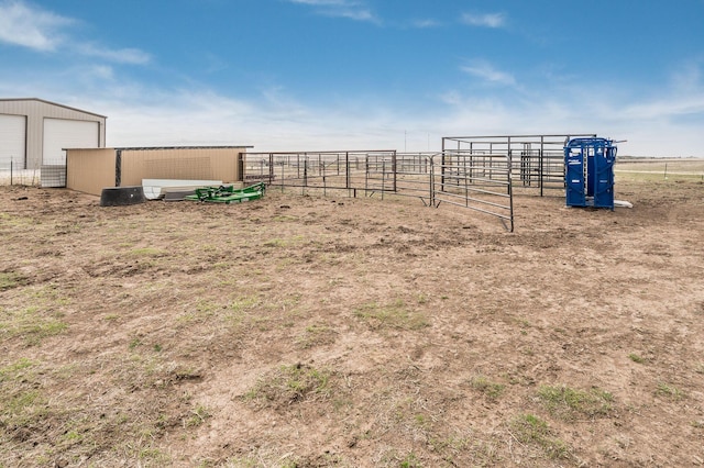 view of yard featuring a rural view and an outdoor structure