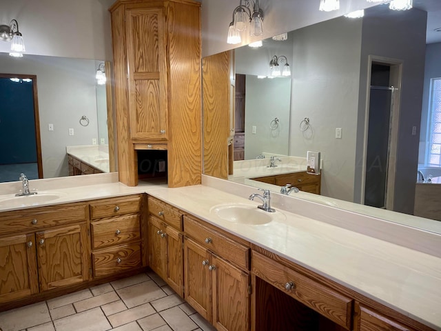 bathroom with tile patterned floors, vanity, and walk in shower