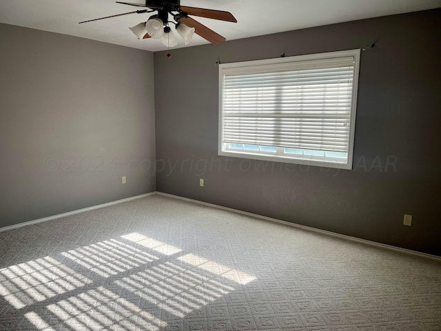 carpeted empty room featuring ceiling fan