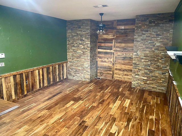 unfurnished dining area featuring hardwood / wood-style floors and ceiling fan