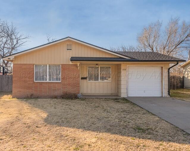 single story home with a garage and a front yard