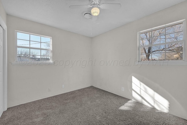 spare room featuring carpet floors and ceiling fan