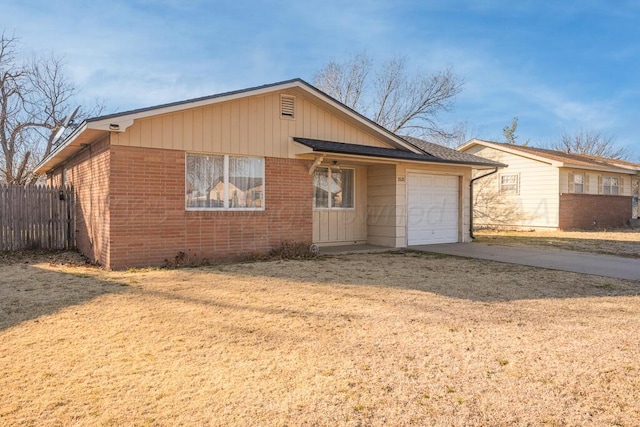 view of front of house with a garage and a front lawn