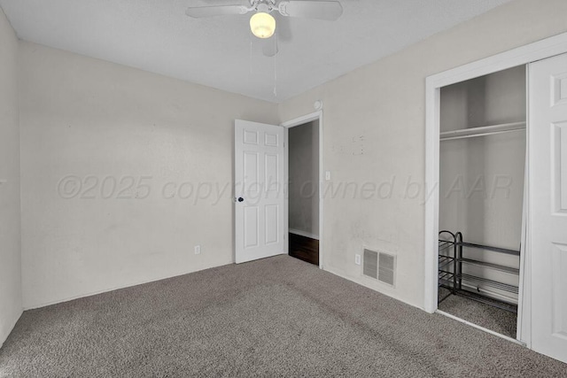 unfurnished bedroom with ceiling fan, carpet floors, and a closet