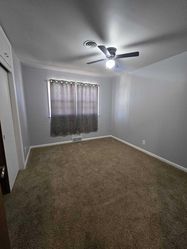 unfurnished bedroom with a closet, baseboards, visible vents, and carpet floors