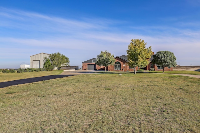 view of front of property featuring a garage and a front lawn