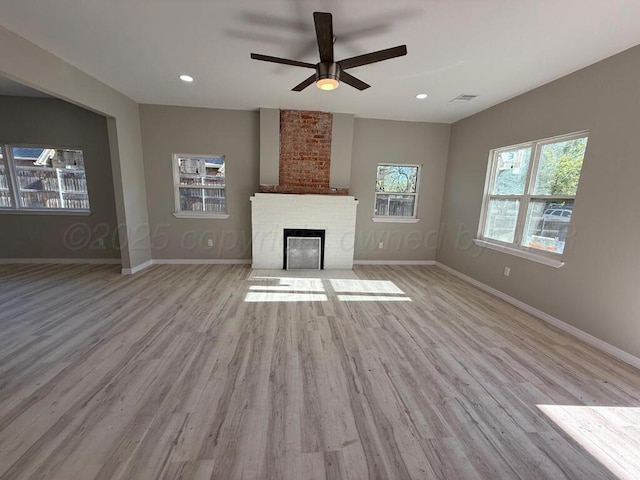 unfurnished living room featuring ceiling fan, wood finished floors, baseboards, a fireplace, and recessed lighting