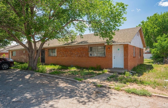 ranch-style house featuring brick siding