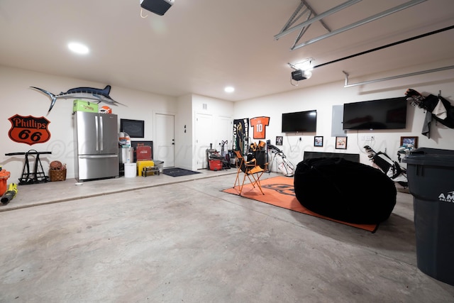 4410 N Rocking Chair Ln, Amarillo, TX 79124 - garage with freestanding refrigerator, a garage door opener, and recessed lighting