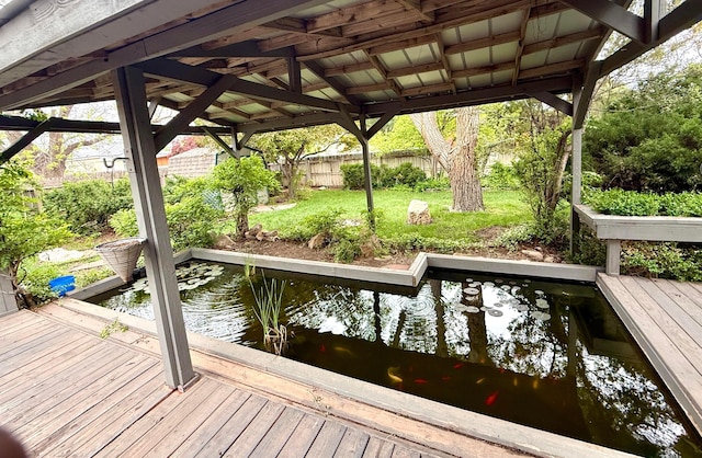 dock area featuring a yard, fence, and a deck