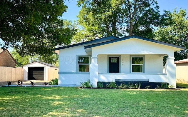 view of front of house featuring a garage, an outdoor structure, and a front yard