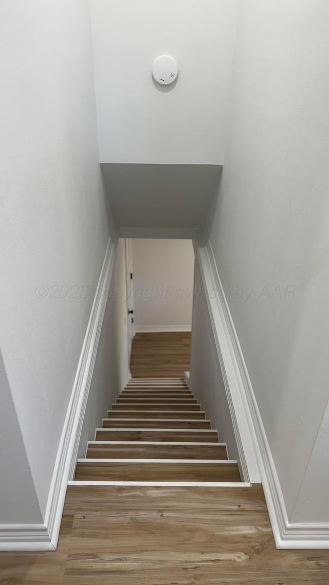 stairway featuring hardwood / wood-style flooring