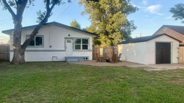 rear view of property with a shed and a yard