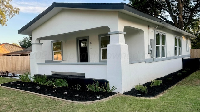 view of side of home featuring a yard