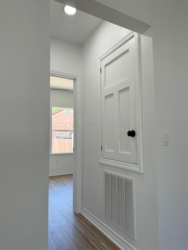 hall with hardwood / wood-style flooring