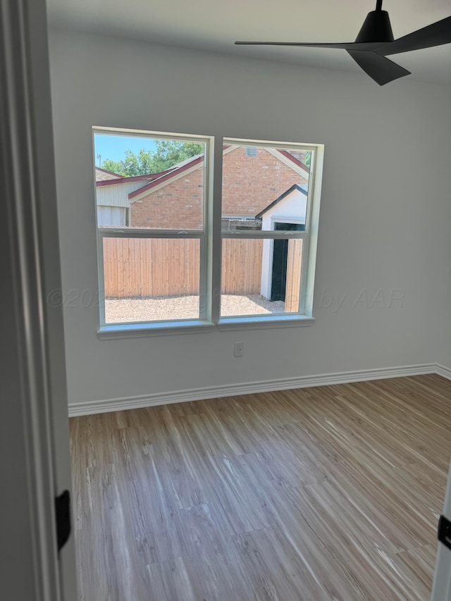 unfurnished room featuring hardwood / wood-style flooring and ceiling fan