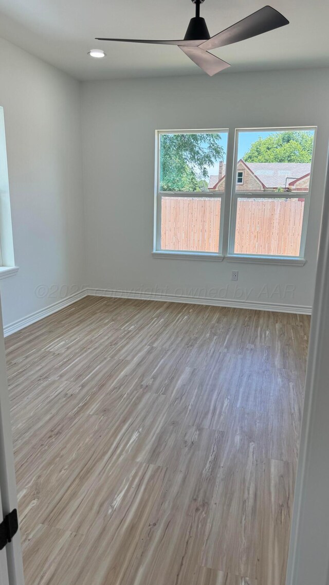 spare room with ceiling fan and light hardwood / wood-style floors