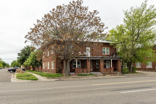 view of front facade with a porch and brick siding