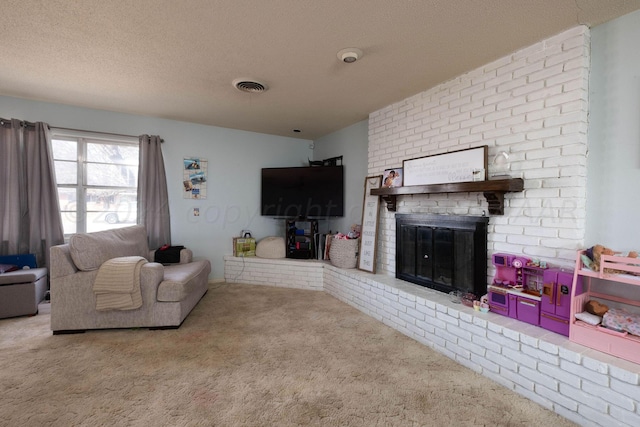 carpeted living room featuring a brick fireplace and a textured ceiling