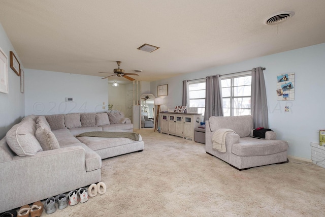 living room with ceiling fan and light colored carpet