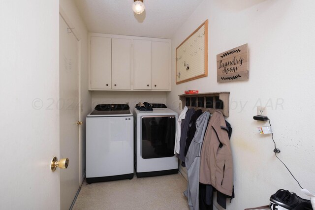 laundry room featuring cabinets and washer and dryer