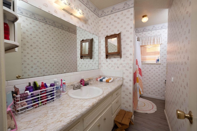 bathroom with vanity and hardwood / wood-style flooring