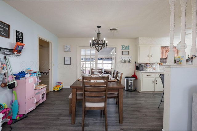 dining space featuring dark hardwood / wood-style flooring and a notable chandelier