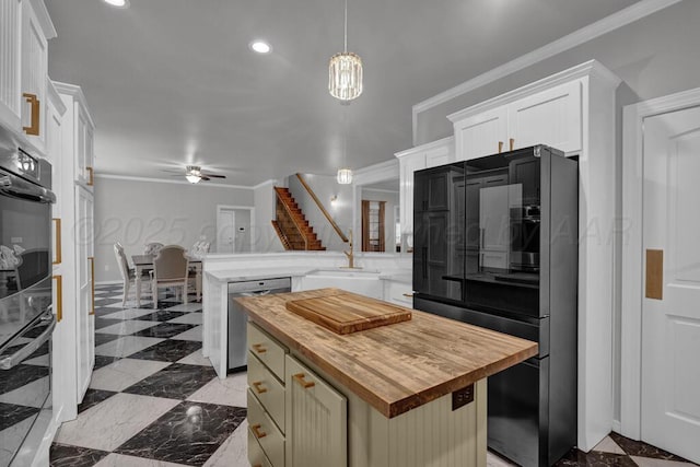 6007 Riley Elizabeth Dr, Amarillo, TX 79119 - kitchen featuring a ceiling fan, a sink, a peninsula, butcher block counters, and stainless steel appliances
