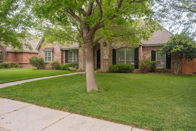 6007 Riley Elizabeth Dr, Amarillo, TX 79119 - view of front facade featuring a shingled roof, a front lawn, and brick siding