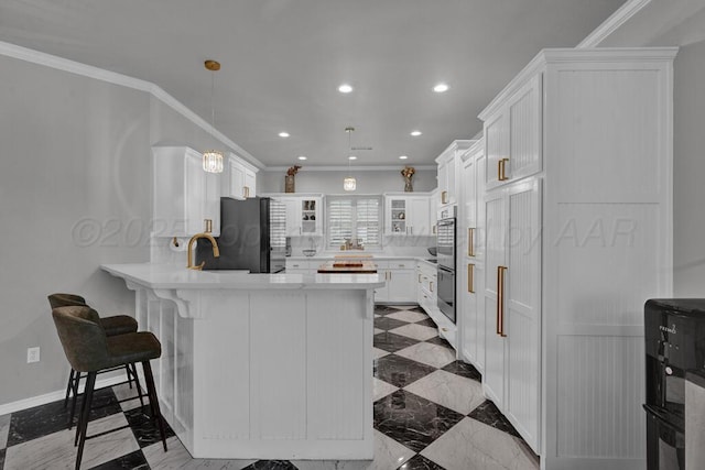 6007 Riley Elizabeth Dr, Amarillo, TX 79119 - kitchen with light countertops, freestanding refrigerator, a peninsula, ornamental molding, and white cabinetry