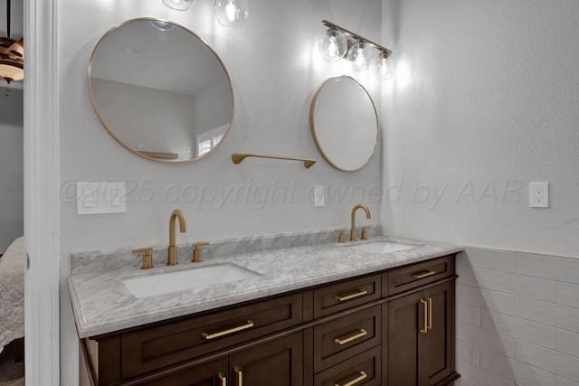 6007 Riley Elizabeth Dr, Amarillo, TX 79119 - bathroom featuring a sink, tile walls, and double vanity