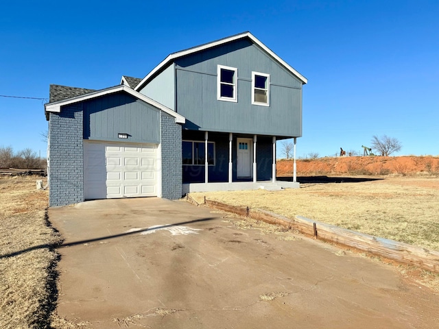 view of front of property with a garage, concrete driveway, and brick siding