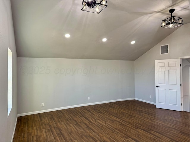 additional living space featuring lofted ceiling, recessed lighting, visible vents, baseboards, and dark wood finished floors