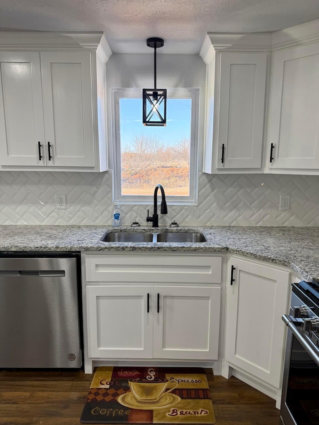 kitchen with dishwasher, light stone counters, a sink, and white cabinets